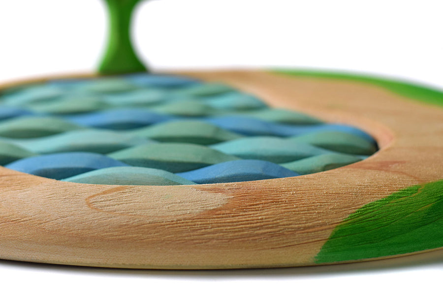 Close up of the wood textures on the sustainable Bumbu lake puzzle on a white background