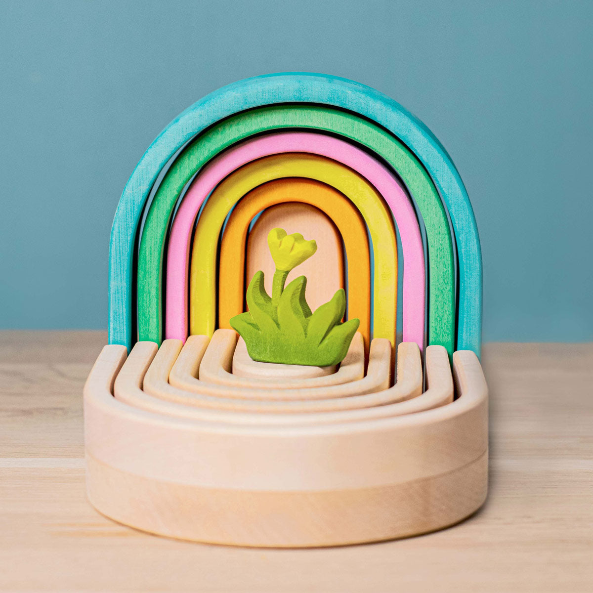 Bumbu toy grass and flower on top of a Bumbu natural wooden rainbow toy