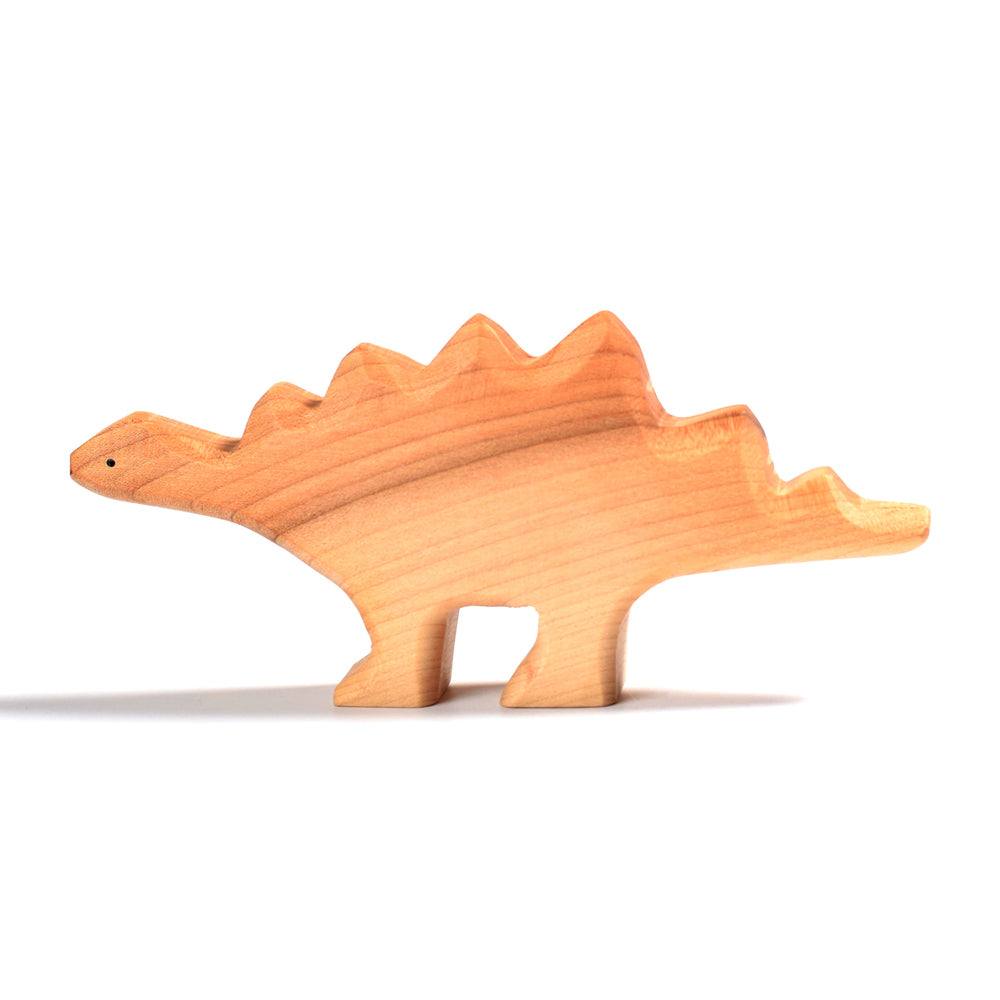 Side of the Bumbu plastic-free wooden stegosaurus dinosaur toy on a white background