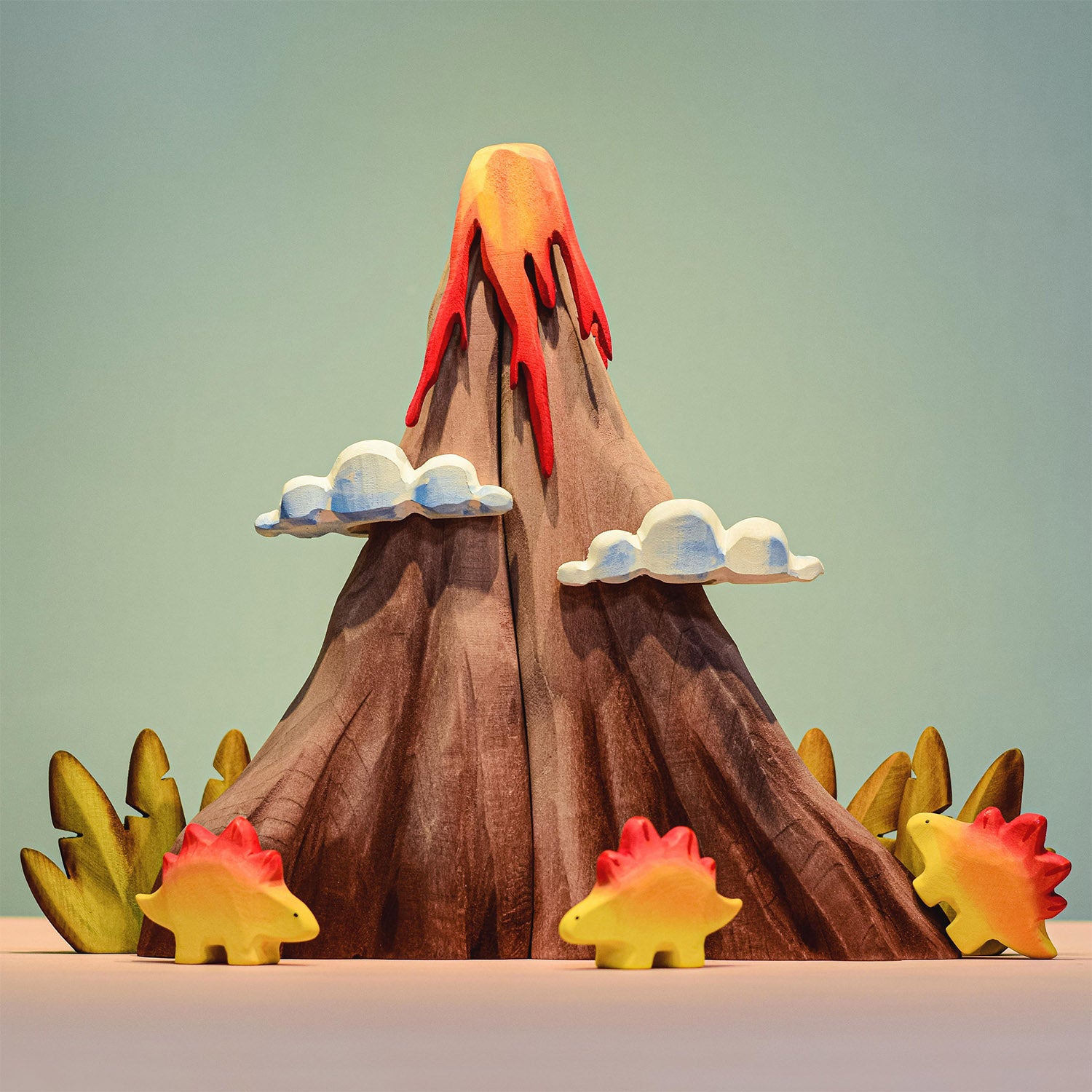 Bumbu Wooden Volcano Set. The toy is paired with dinosaurs and Jurassic fauna.