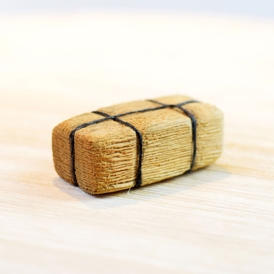 Bumbu handmade plastic free hay bail toy on a light wooden background