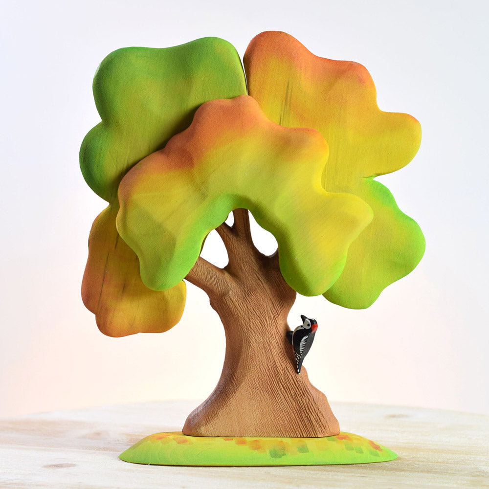 Bumbu handmade wooden autumn oak tree and woodpecker toy set on a wooden worktop