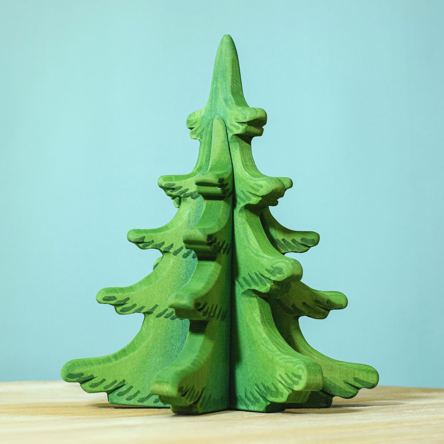 Bumbu Large Green Sugar Pine Tree pictured on a blue background