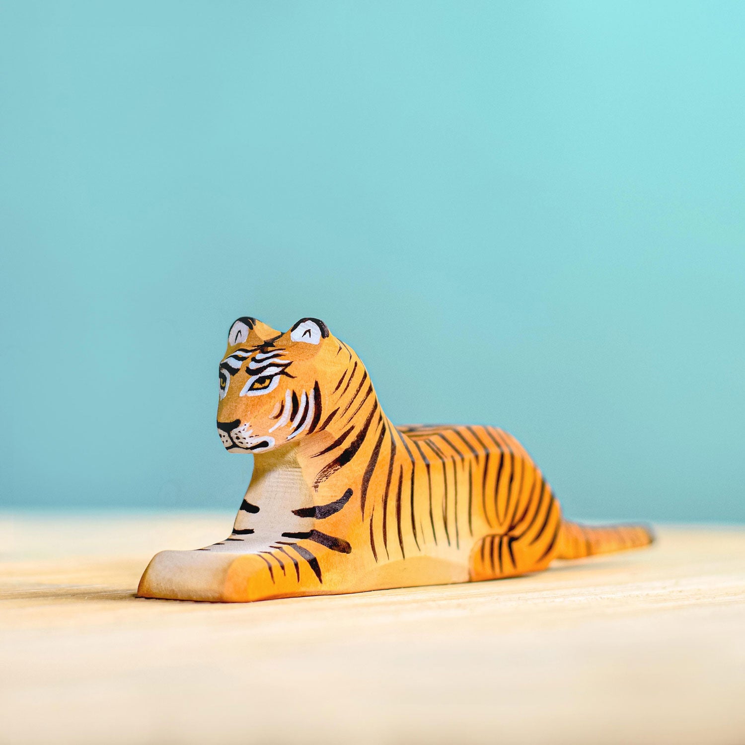 Bumbu Wooden Lying Tiger  pictured on a blue background