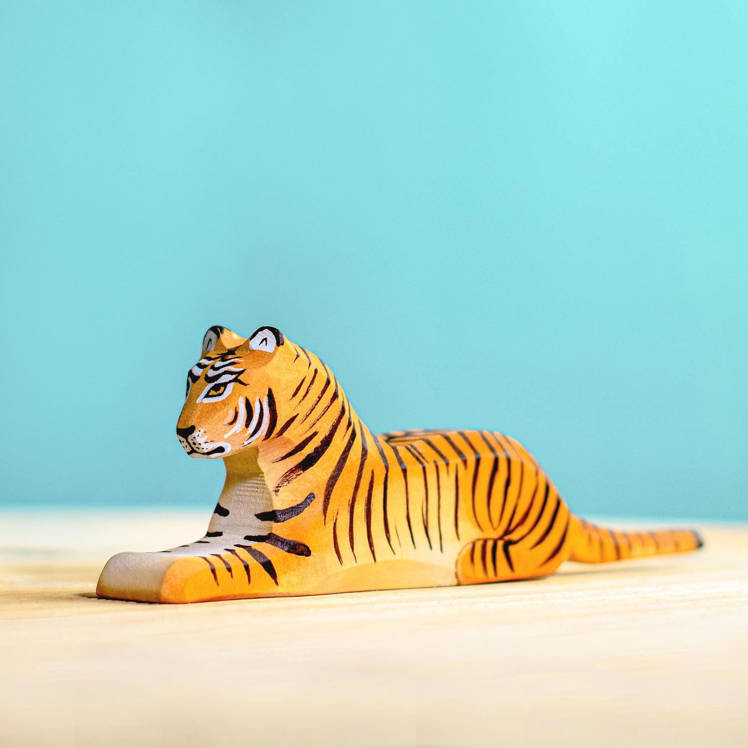 Bumbu Wooden Lying Tiger  pictured on a blue background