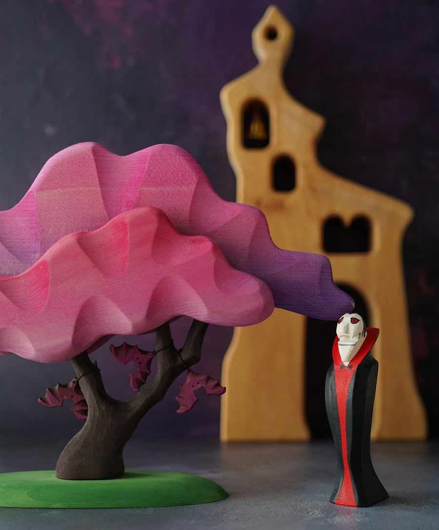 Bumbu Wooden Halloween Handmade Vampire Toy next to Pink Bumbu Japanese Maple Tree with bats