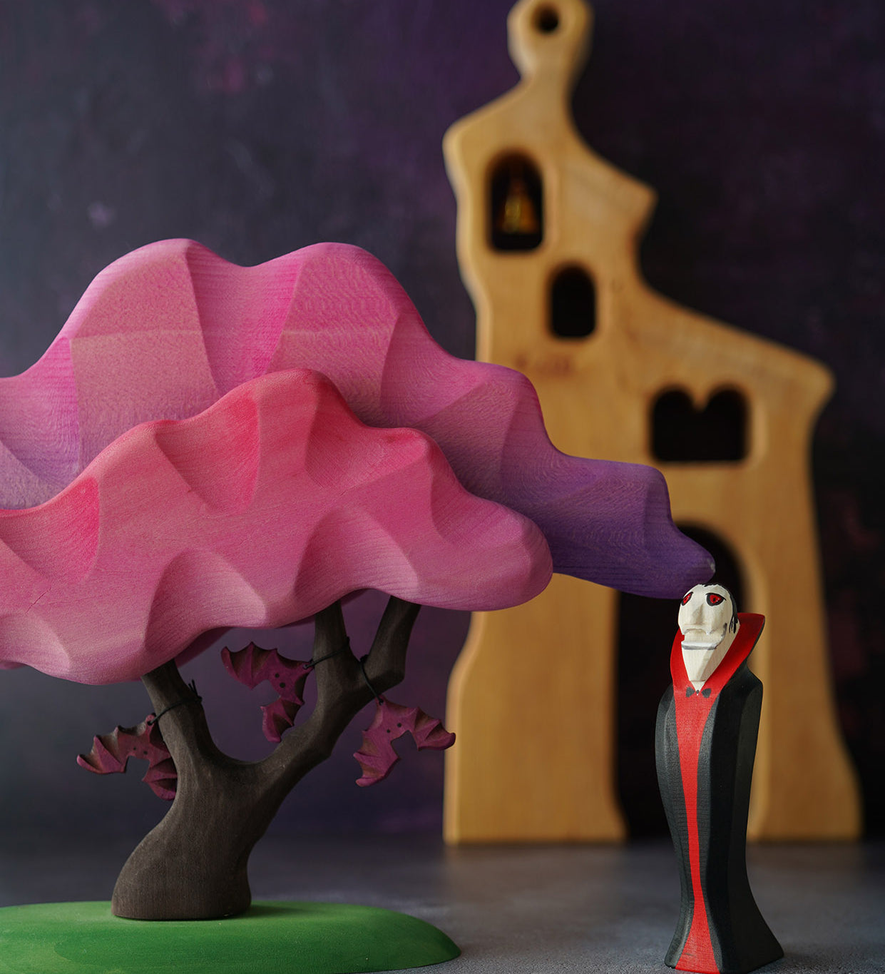 Bumbu Wooden Halloween Handmade Vampire Toy next to Pink Bumbu Japanese Maple Tree with bats