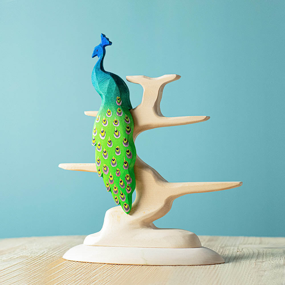 Bumbu plastic-free natural wooden bird tree with a Bumbu peacock figure balanced on top