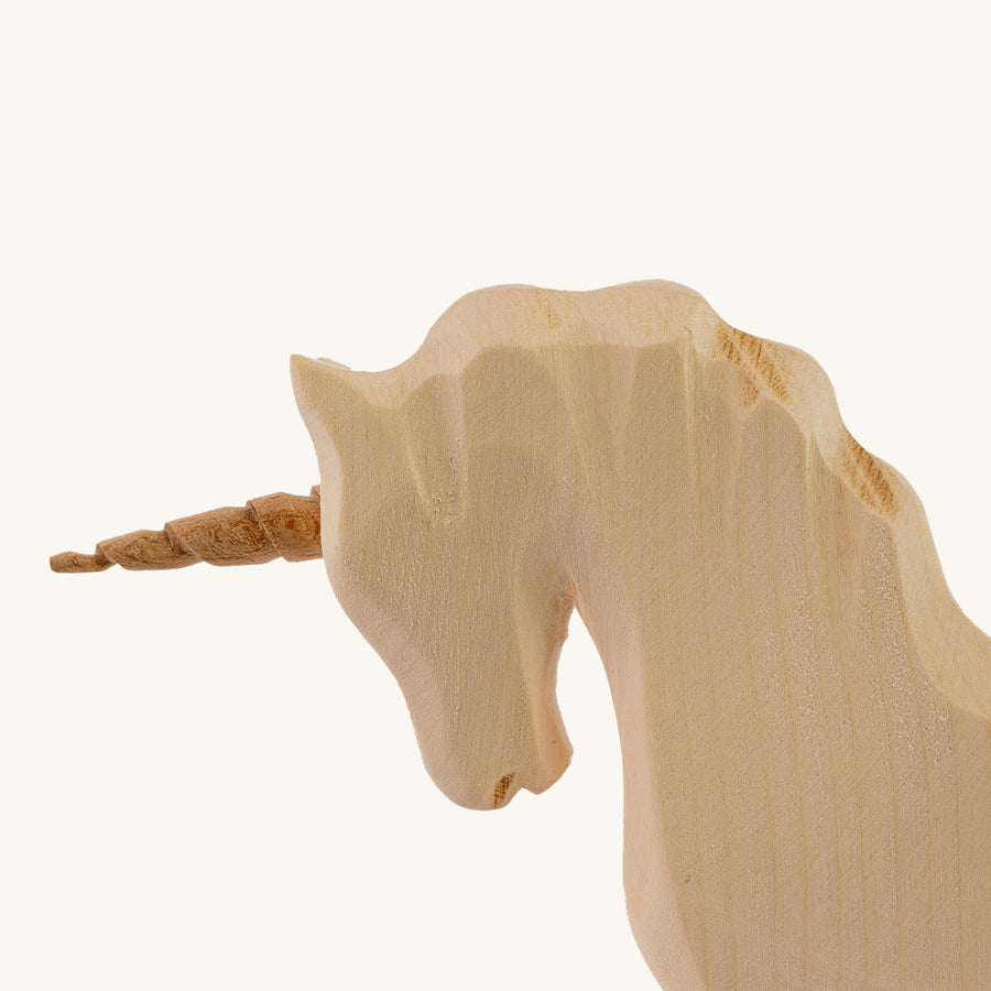 Bumbu Natural Wood Unicorn on a plain background. Close-up of head detail.