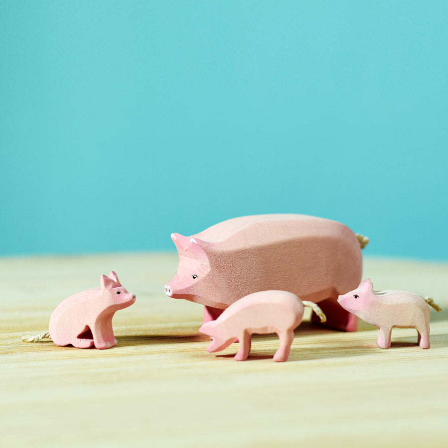 Bumbu Wooden pig family pictured on a blue background