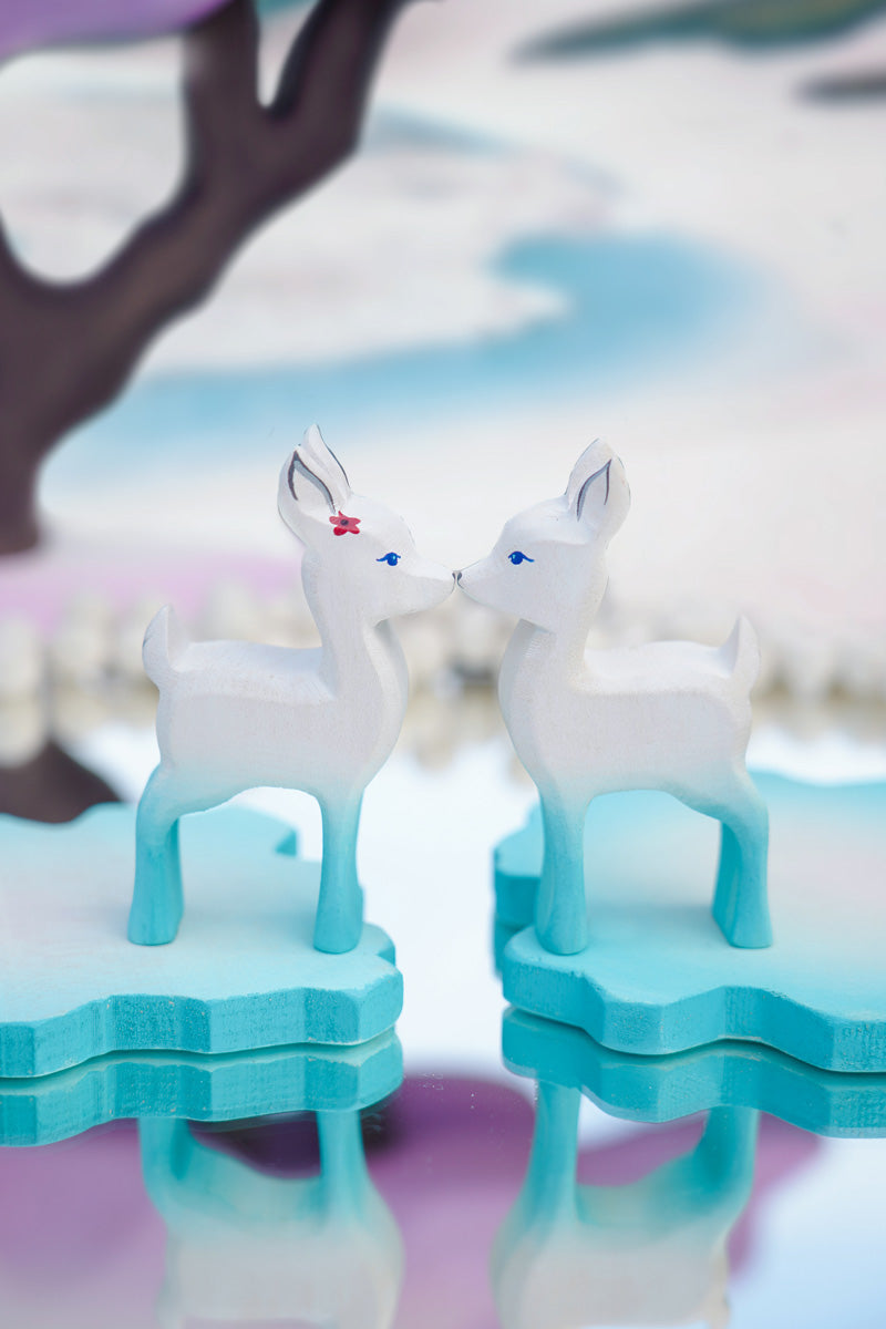 Close up of two Bumbu fawn toys stood face to face on some Bumbu ice floe blocks