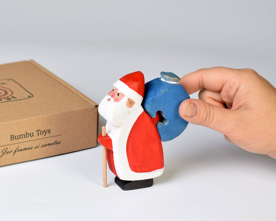 Close up of a hand holding the Bumbu plastic-free Father Christmas toy