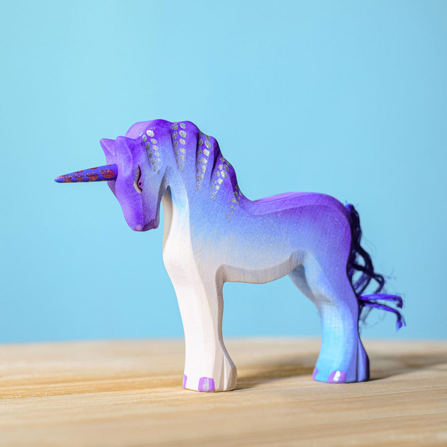 Bumbu Purple Unicorn pictured on a wooden surface with a blue wall in the background