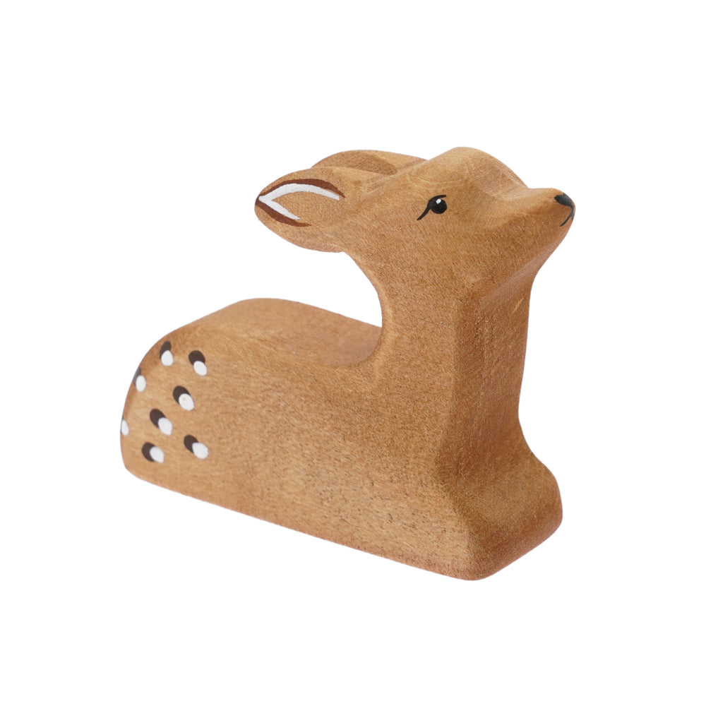 Bumbu hand carved resting wooden fawn toy figure on a white background