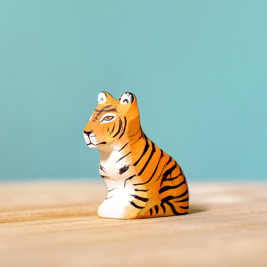 Bumbu Wooden Sitting Tiger Cub pictured on a blue background