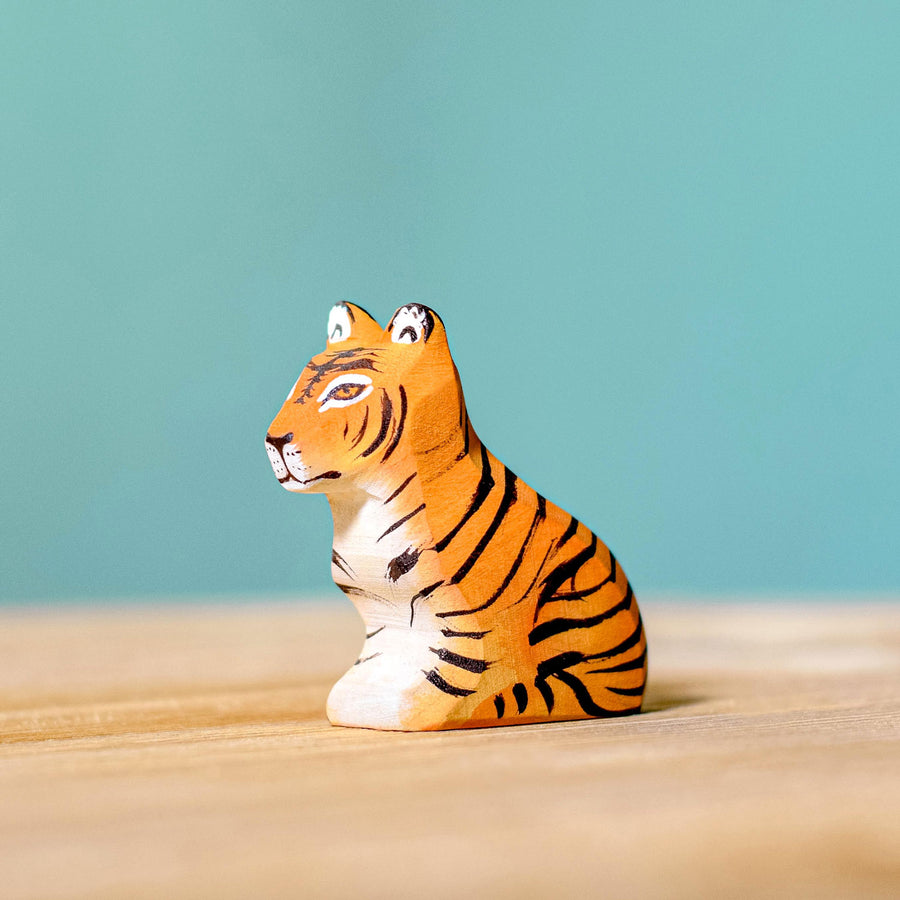 Bumbu Wooden Sitting Tiger Cub pictured on a blue background