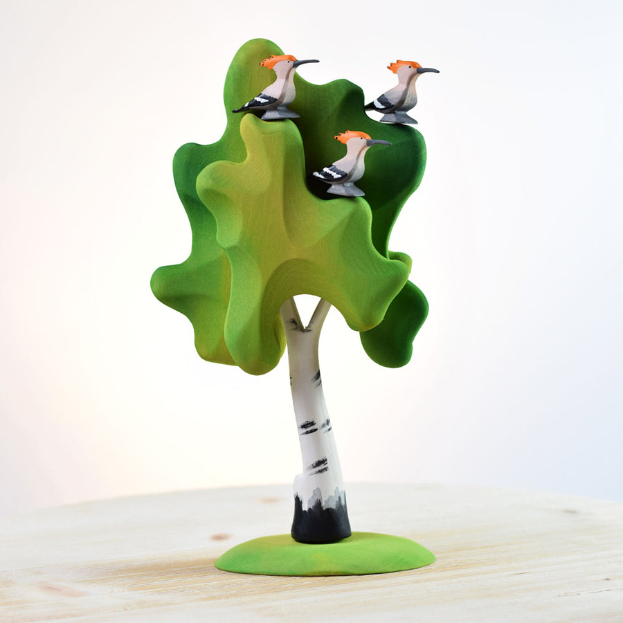 three Bumbu eco-friendly and plastic free wooden hoopoe birds in a wooden tree toy on a wooden table