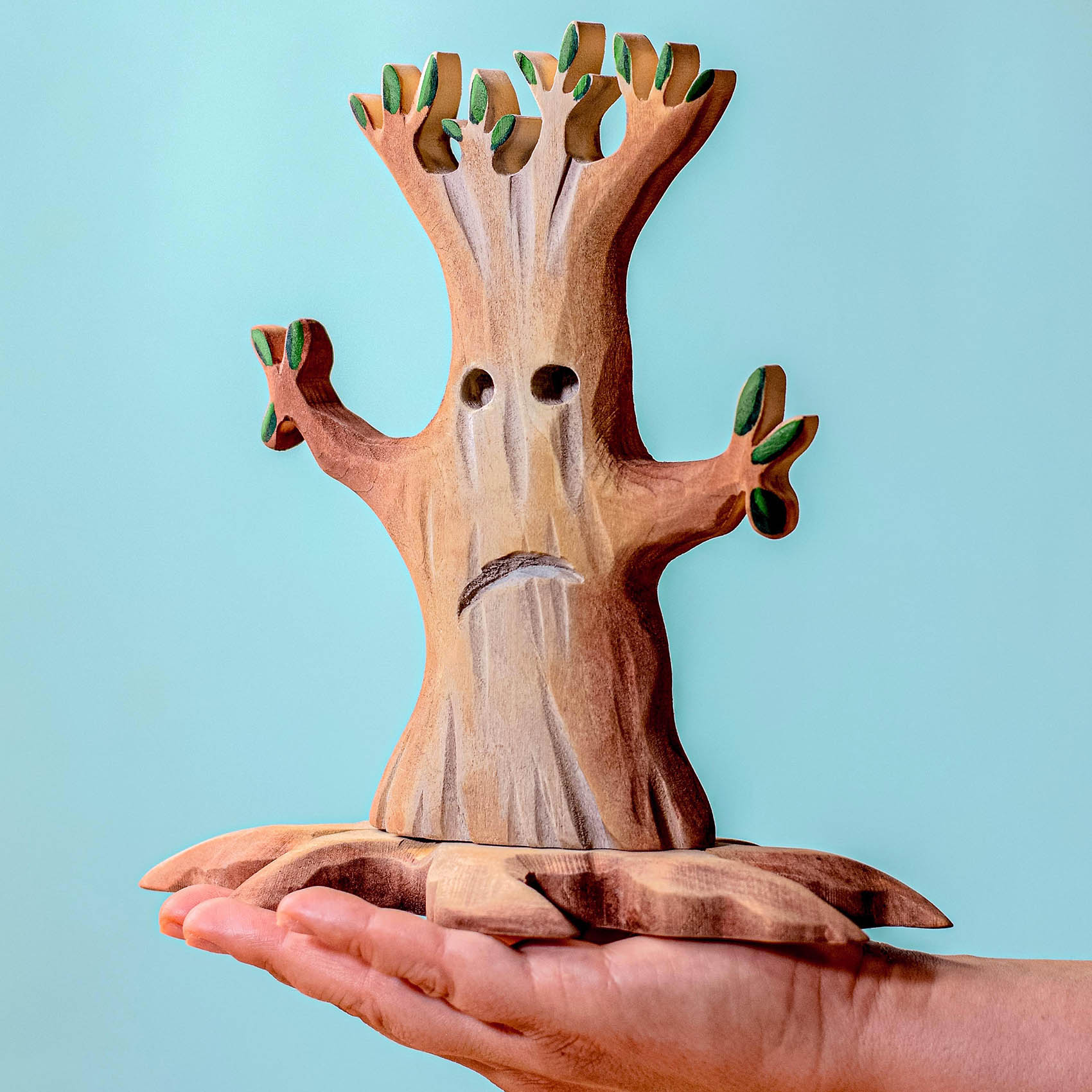 a hand carved wooden toy in the shape of a spooky Halloween tree