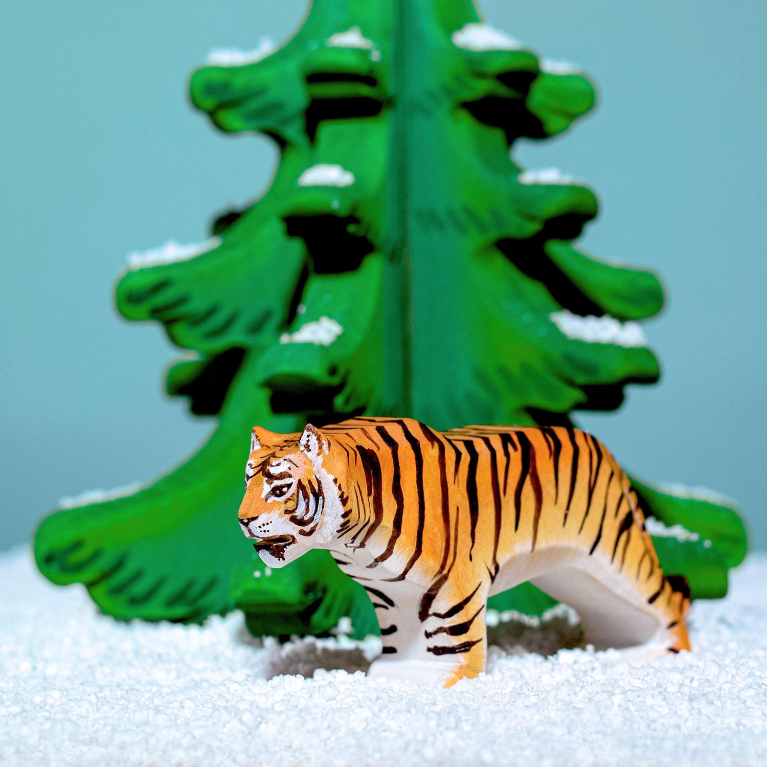 Bumbu Wooden Standing Tiger standing in front of the green sugar pine tree