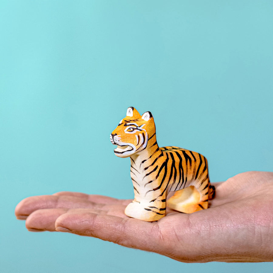 Person holding the Bumbu Wooden Standing Tiger Cub in their hand