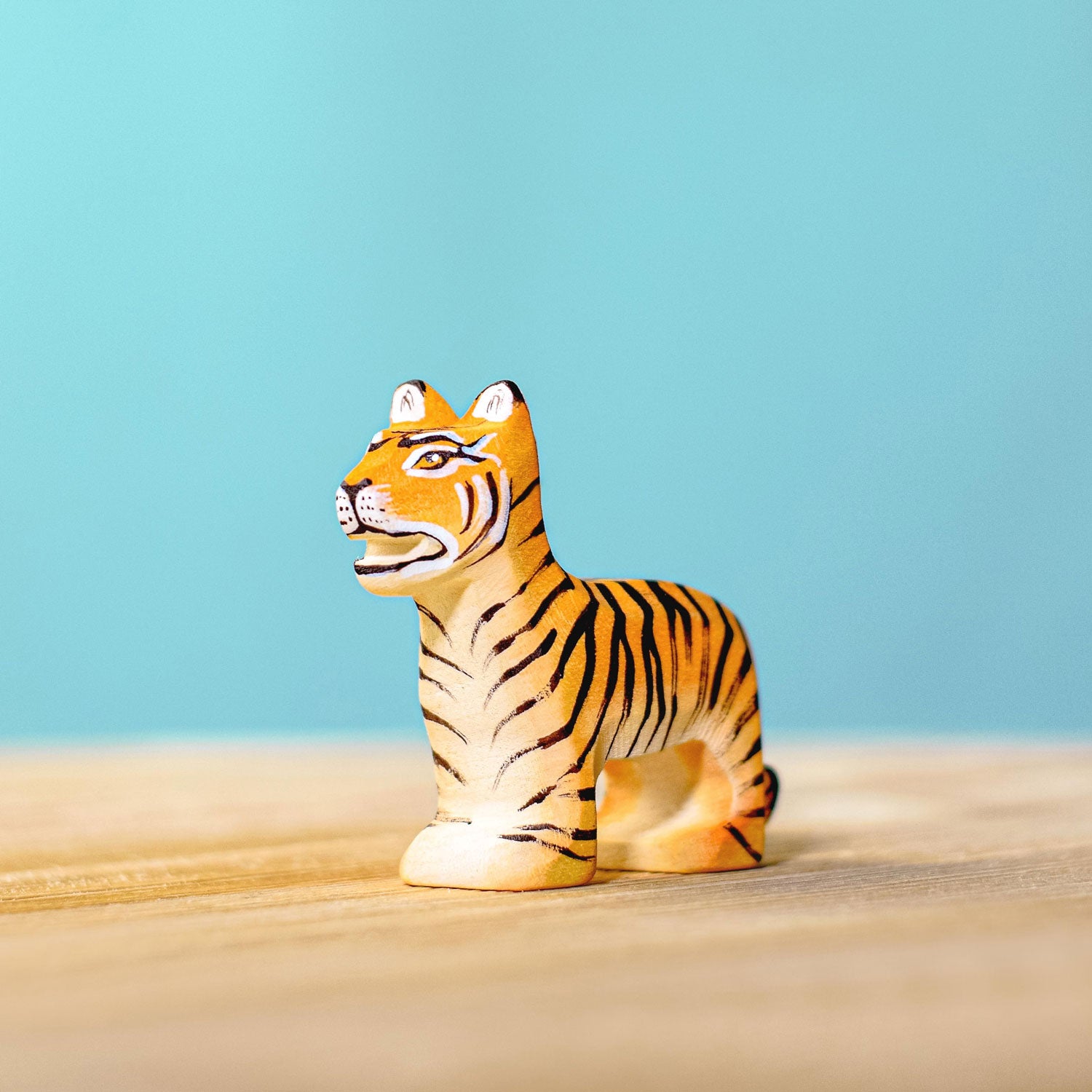 Bumbu Wooden Standing Tiger Cub pictured on a blue background