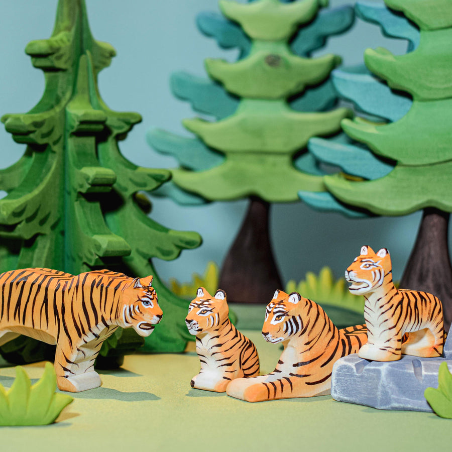 Bumbu wooden tiger family with sugar pine and spruce trees in the background