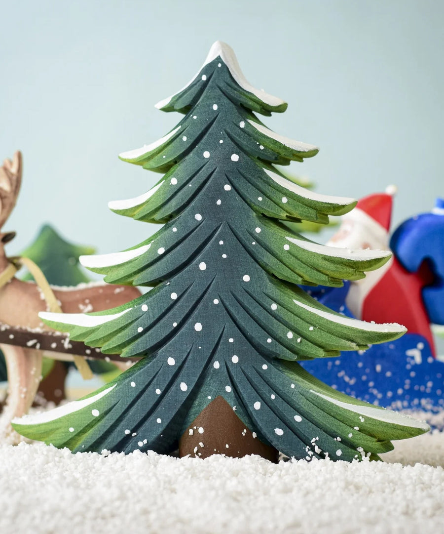 A large Bumbu Snowy Fir Tree placed in the centre of a festive small world play scene. 