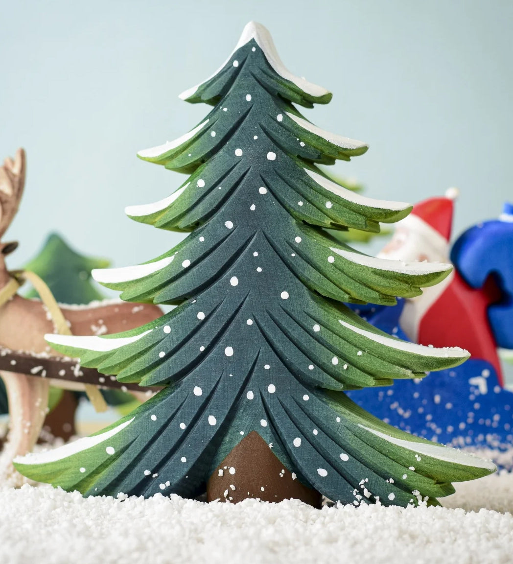 A large Bumbu Snowy Fir Tree placed in the centre of a festive small world play scene. 