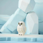 The Bumbu Toys Snowy Owl Chick placed on a Bumbu ice floe with the Bumbu icy rocks in the background. 