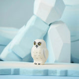 The Bumbu Toys Snowy Owl Chick placed on a Bumbu ice floe with the Bumbu icy rocks in the background. 