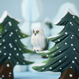 A Bumbu Toys Snowy Owl Chick sitting on a branch of the Bumbu snowy tree. 