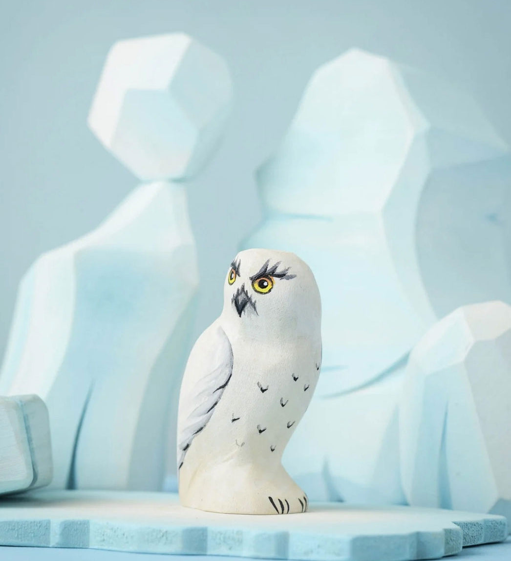 The Bumbu Toys Snowy Owl on a Bumbu ice flo in front of the Bumbu icy cliffs.