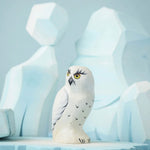 The Bumbu Toys Snowy Owl on a Bumbu ice flo in front of the Bumbu icy cliffs.