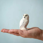 The Bumbu Toys Snowy Owl on the palm of an adult's hand. 