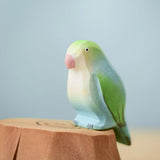 Bumbu wooden blue lovebird figure perched on a Bumbu wooden stump