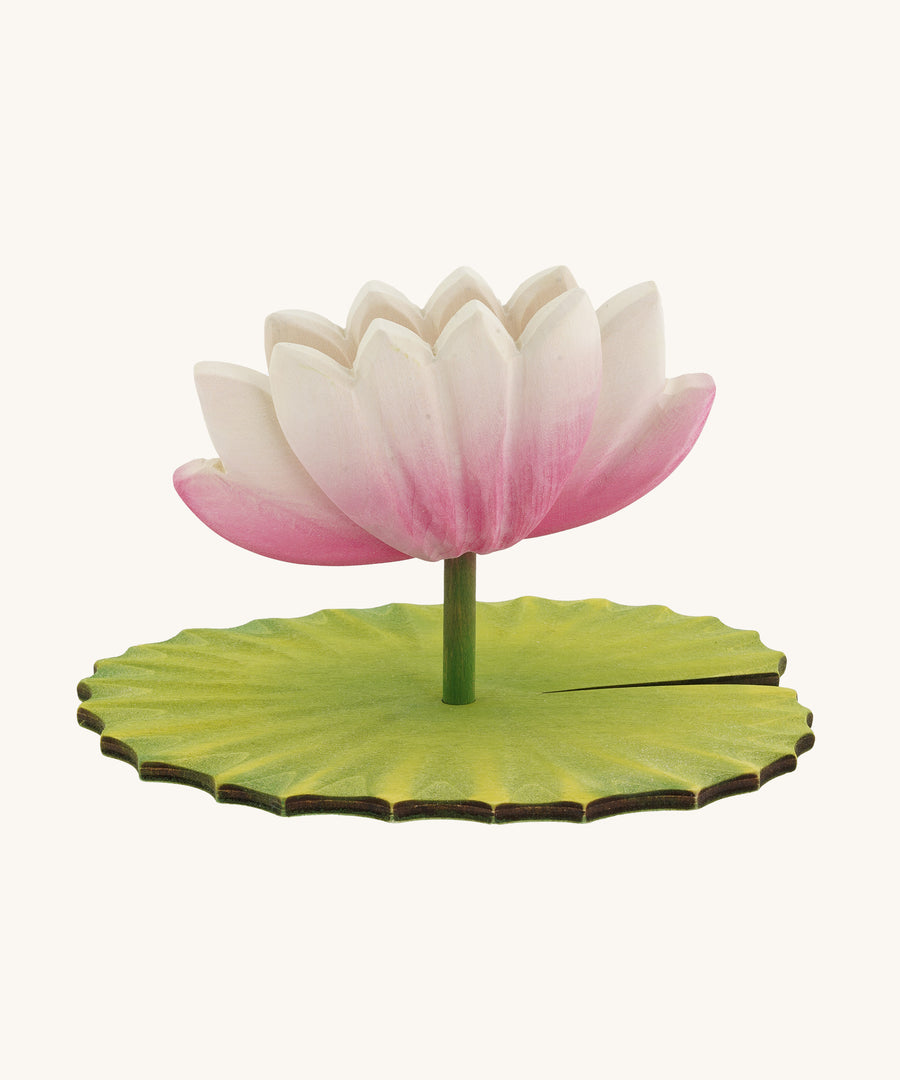 A Hand Crafted and Hand Painted Large Bumbu Wooden Lotus Flower. The figure has a pink and white Lotus Flower with a green stalk and green base, which has been handmade and hand painted, pictured on a plain background 