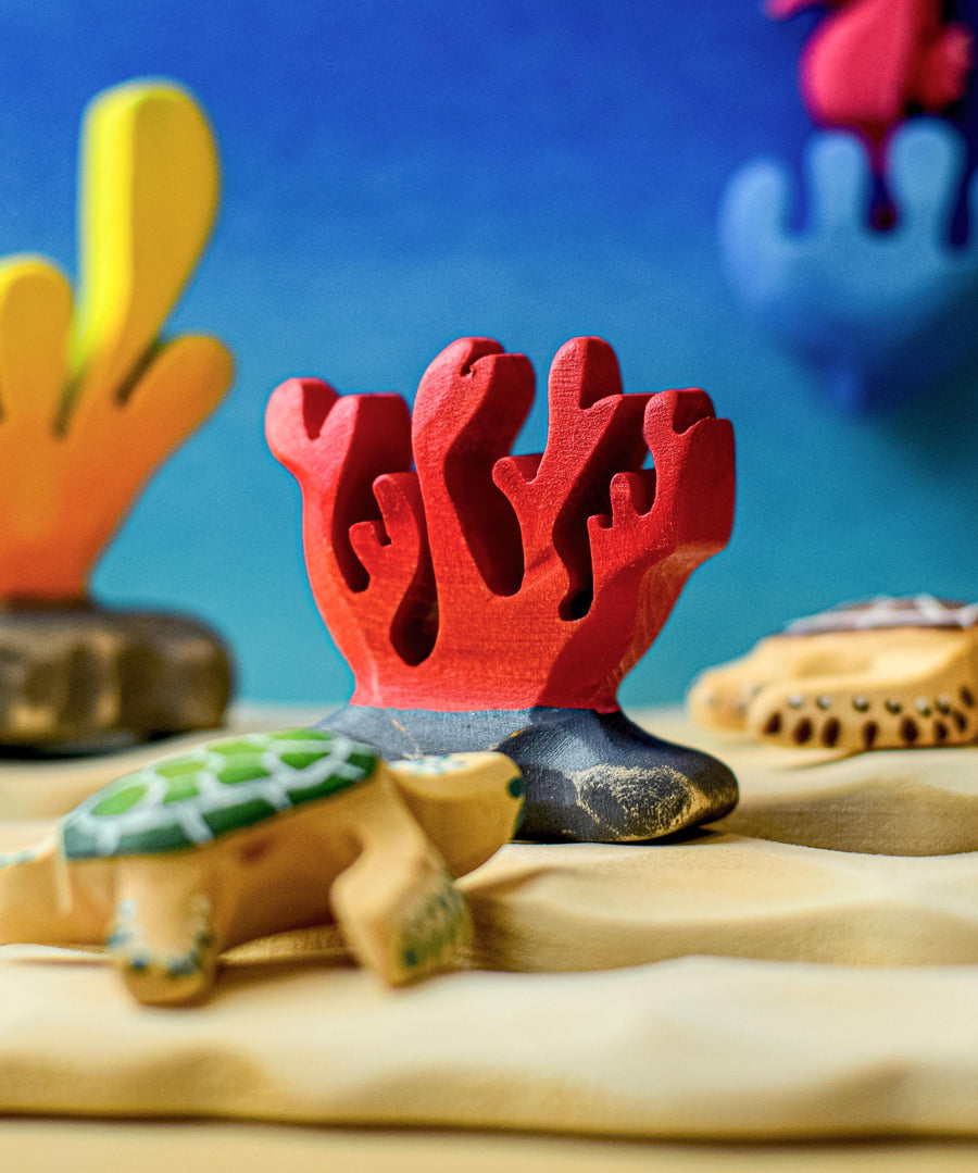 A red Bumbu wooden coral figure set up in an ocean themed small world play.