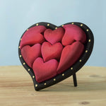 Bumbu wooden red hearts puzzle set in a wooden heart frame standing on a table