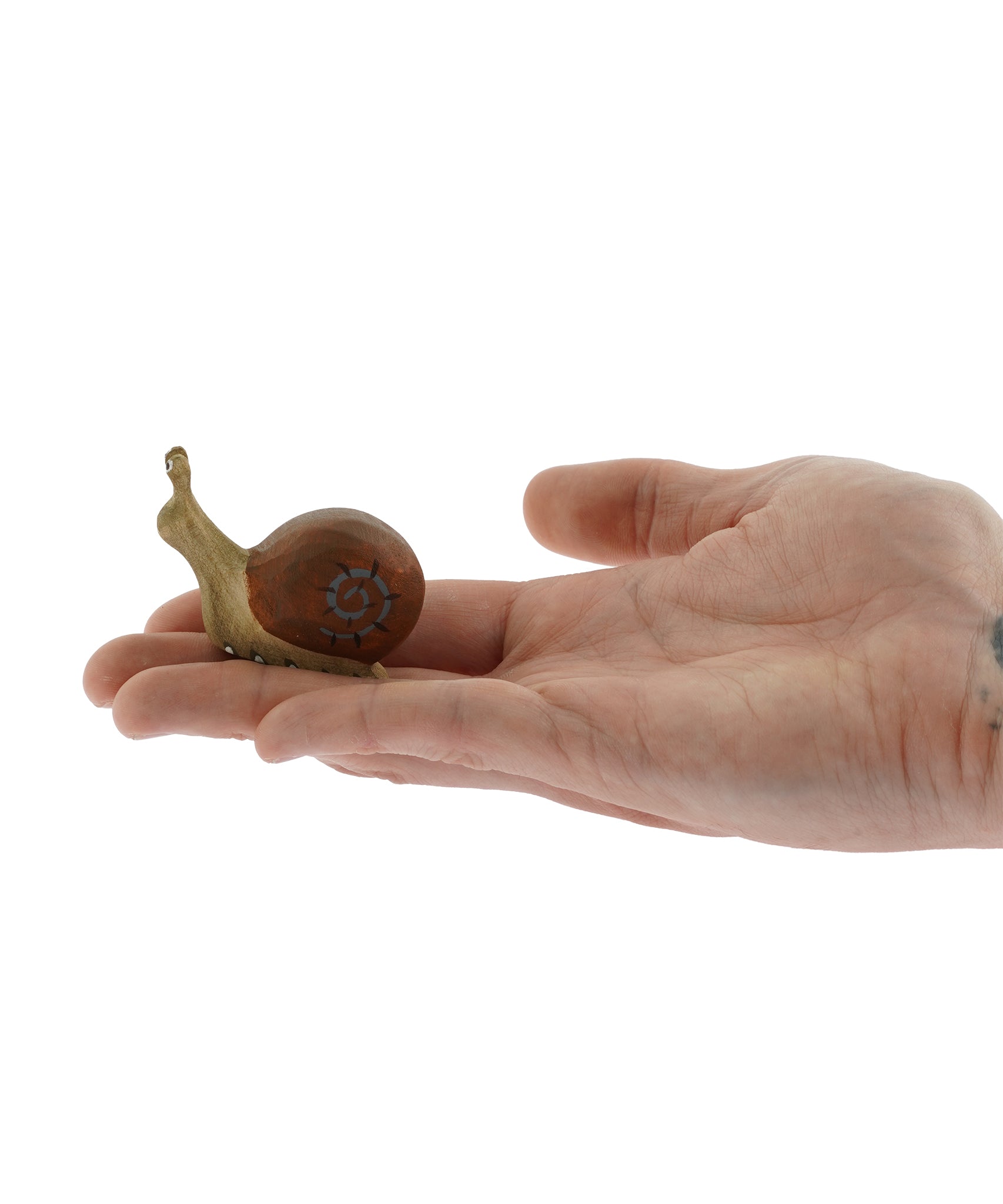 Side view of the Bumbu wooden snail figure on a plain background 