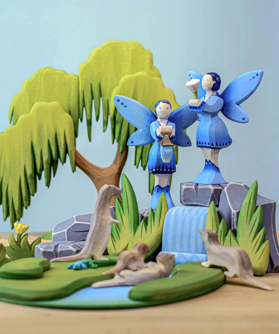 Two Bumbu water fairies in a small world play scene  featuring the bumbu waterfall, willow tree and otters.