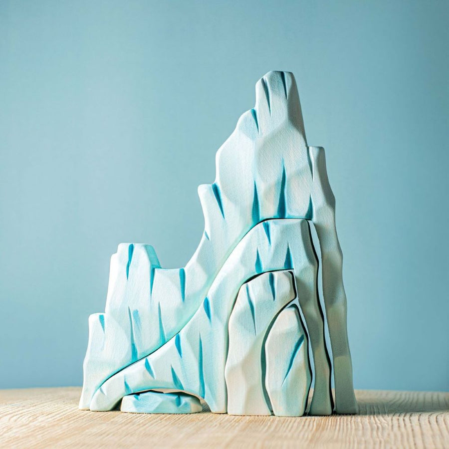 The Bumbu Icy Cliffs is a set of 5 handmade wooden blocks that stack together to make an icy mountain scene. Hand carved and painted in shades of white and blue to represent glaciers