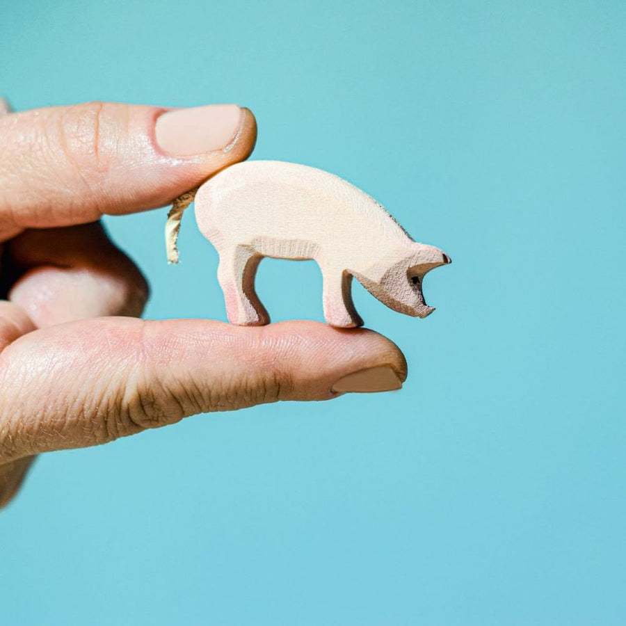 The Bumbu Eating Piglet is a beautiful eco-friendly wooden miniature pig toy