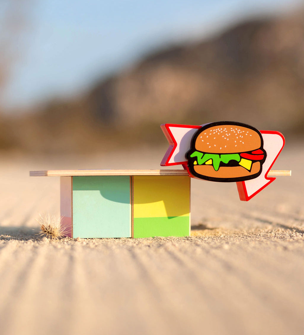 Candylab Burger Food Roadside Shack on a sandy surface outdoors.  