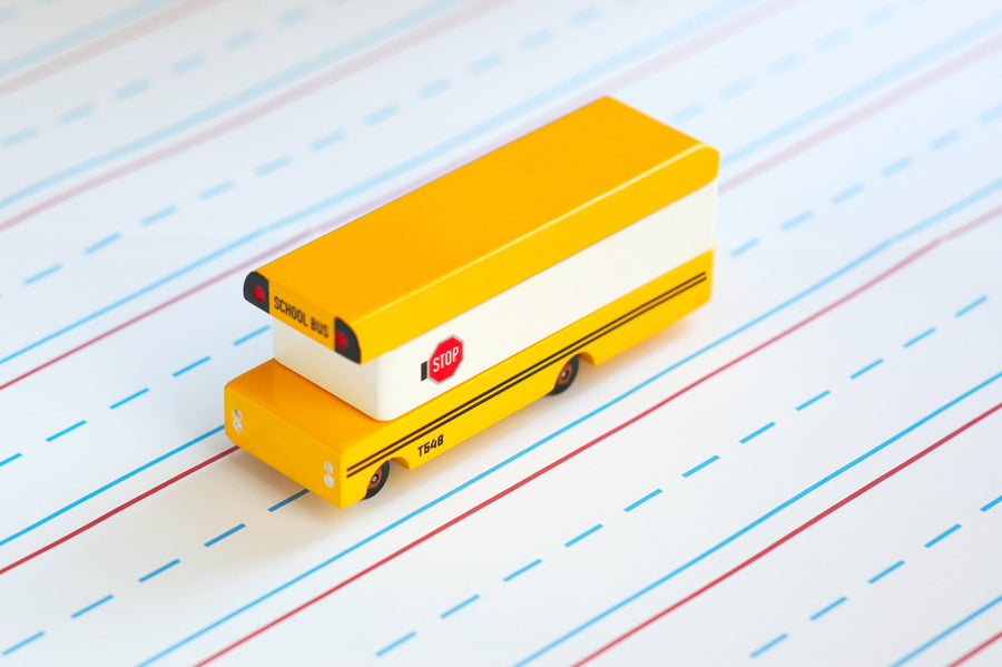 Candylab solid wooden diecast bus toy on some white