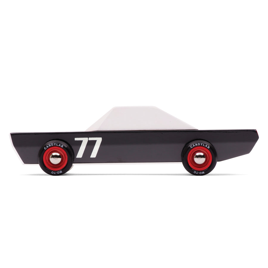 Side of the Candylab handmade wooden Carbon 77 toy race car on a white background