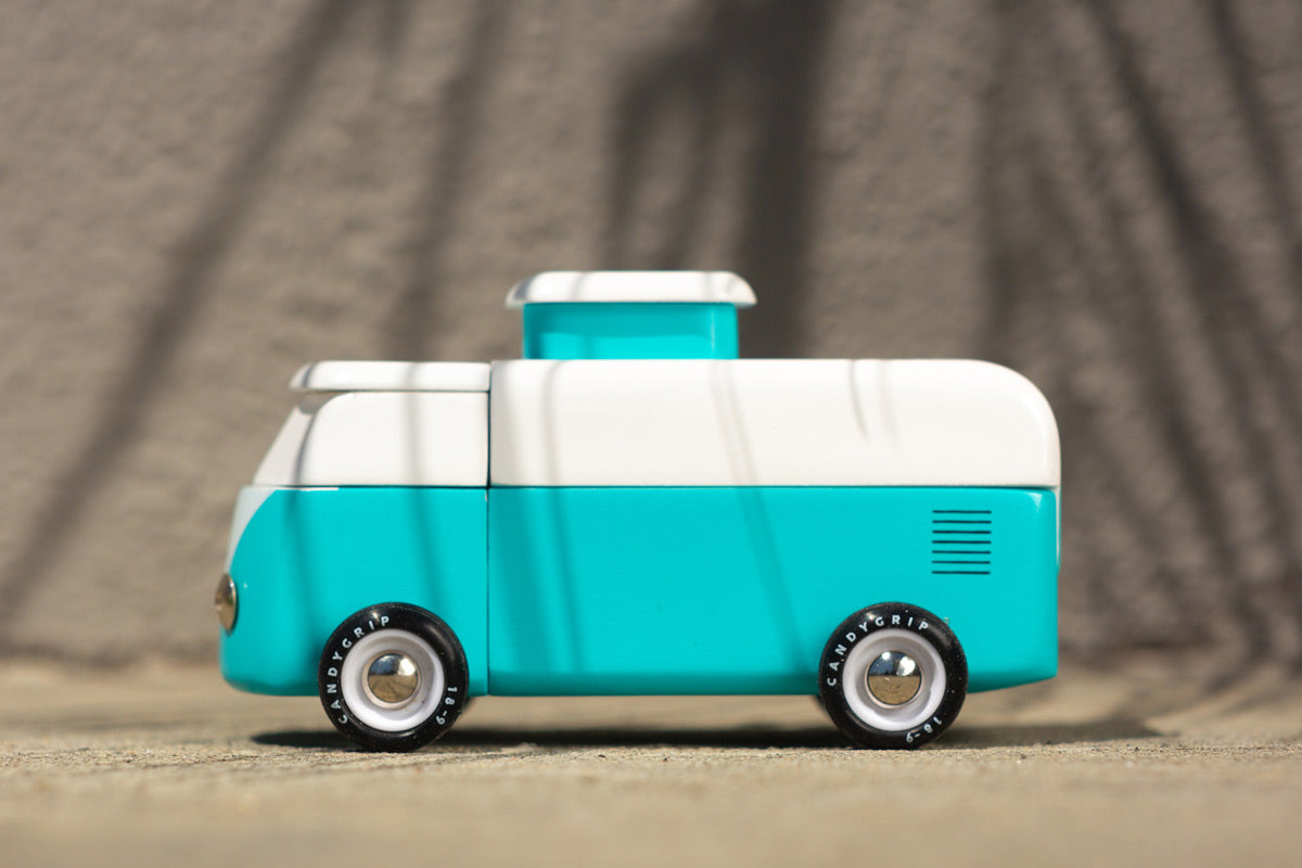 Side of the candylab handmade magnetic beach van toy on a sand background