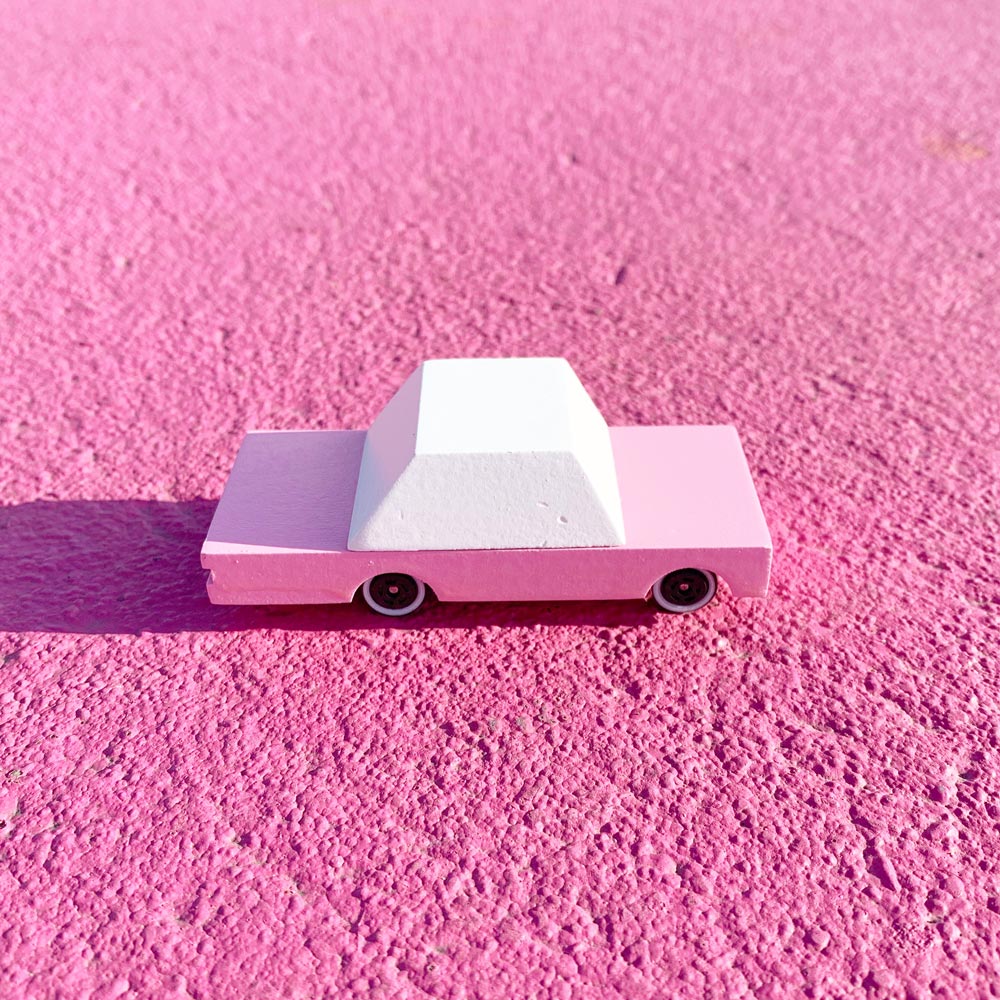 Candylab childrens pink wooden sedan car toy on a pink floor