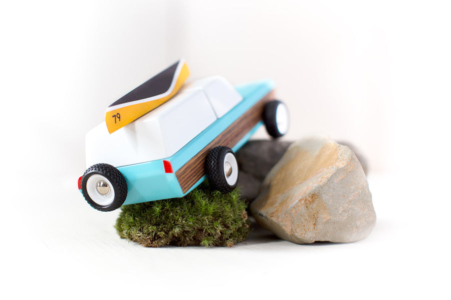 Candylab childrens collectable blue car toy on some grey rocks and small ball of moss