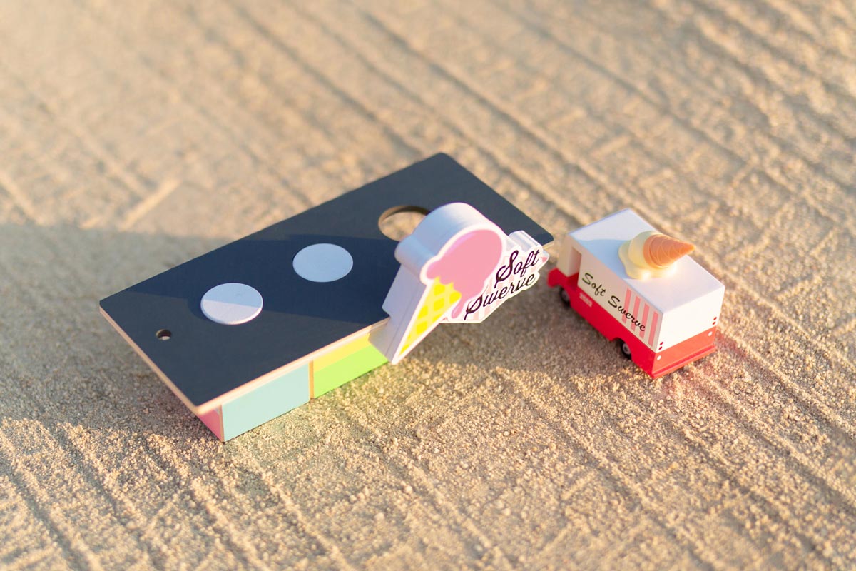 Candylab eco-friendly ice cream shack and ice cream van toys on a sandy background