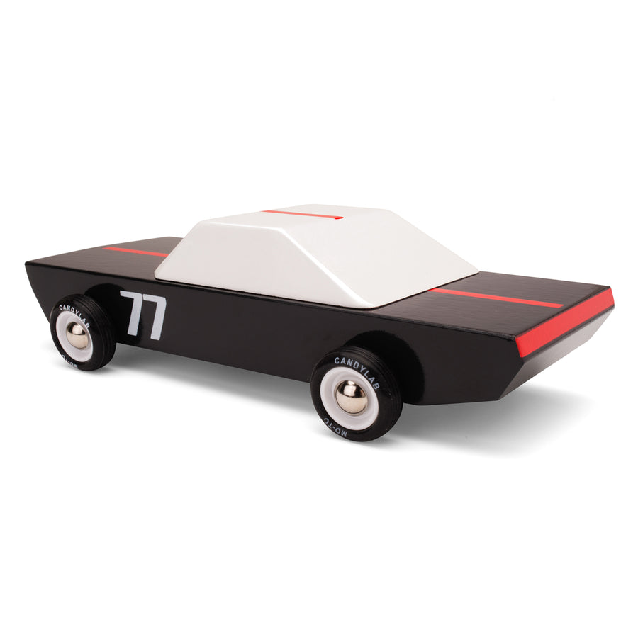 black and white wooden racing car toy on a white background